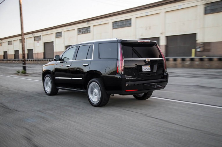 2015-cadillac-escalade-platinum-rear-three-quarter-in-motion