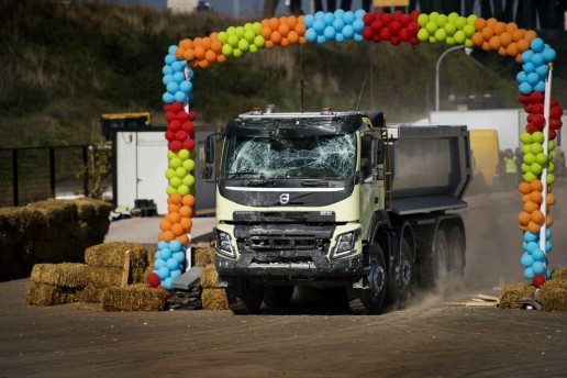 A little girl drives a heavy-duty Volvo truck