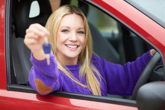 Teenage Girl Standing Next To Car Holding Key