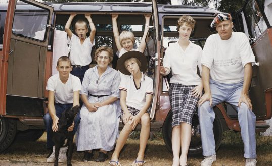 Family sitting in retro bus posing