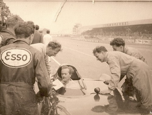 Colin Chapman in Lotus J Crosthwaite leaning on car right 500x379