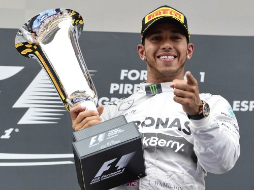 Mercedes-AMG's British driver Lewis Hamilton celebrates on the podium 