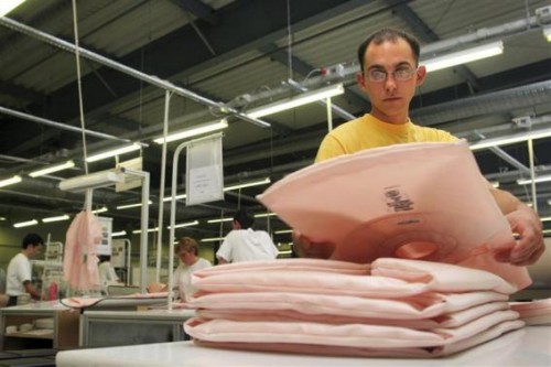 Man arranges airbag cushions manufactured by Japanese car parts maker Takata Corp in Sibiu